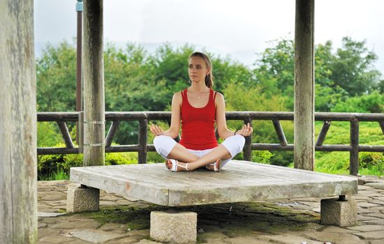 Young woman practicing yoga outdoors