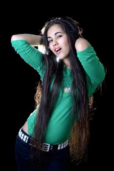 Pretty young woman unbinding her long hair. Isolated