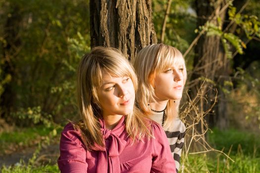 Two beauty young blondes in the light of the sunset