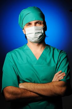 Surgeon in mask over blue