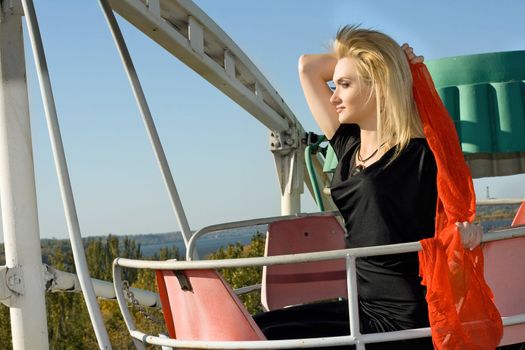 Young pretty woman riding a Ferris wheel