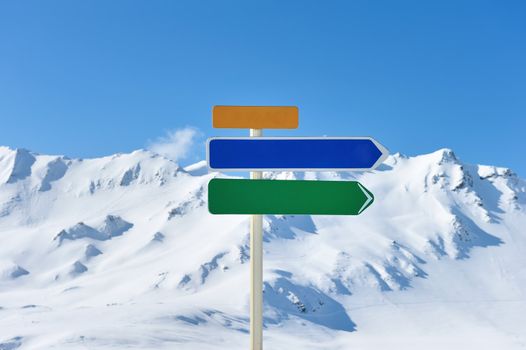 Arrow sign at mountains with snow in winter, Val-d'Isere, Alps, France