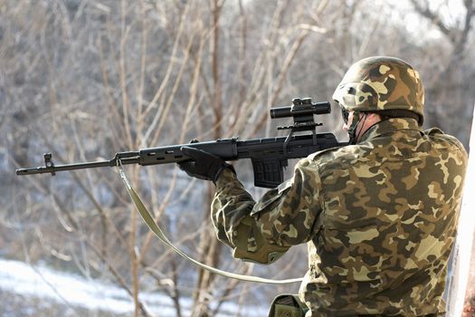 Portrait of soldier with a sniper rifle in his hands