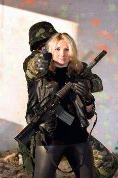 Soldier with a gun and girl with rifle