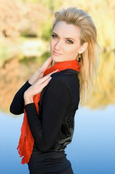 Portrait of a young pretty blonde in autumn park