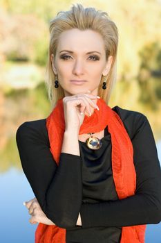 Portrait of a young blonde in autumn park