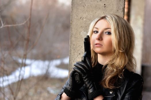 Stunning girl with a weapon in abandoned building