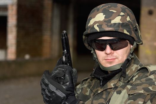 Brave man with a gun in neglected house