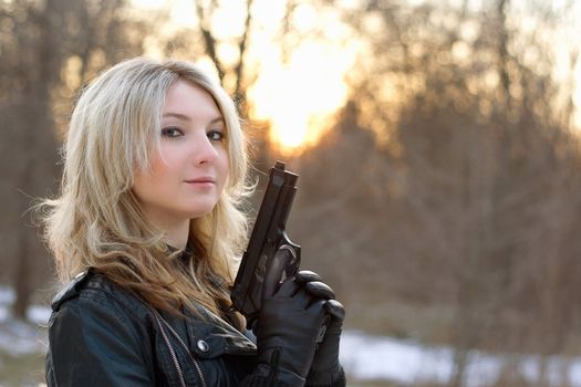 Provocative young woman at sunset in winter forest