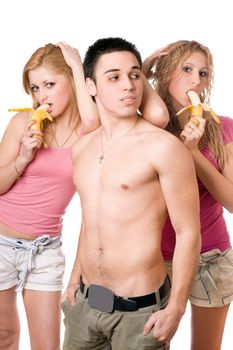 Young man and two pretty women with bananas. Isolated