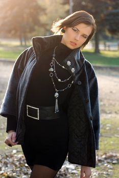 Portrait of an elegant young woman in autumn park