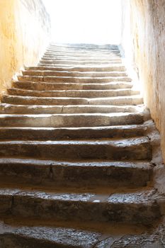 Old stone stairway leading up to the blinding light. These are the stairs leading to the entrance of the Castle of St Peter in Bodrum, Mugla Province, Turkey.