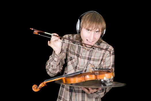 The young man in ear-phones eats a violin