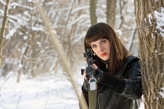 Portrait of gorgeous young woman with a sniper rifle 