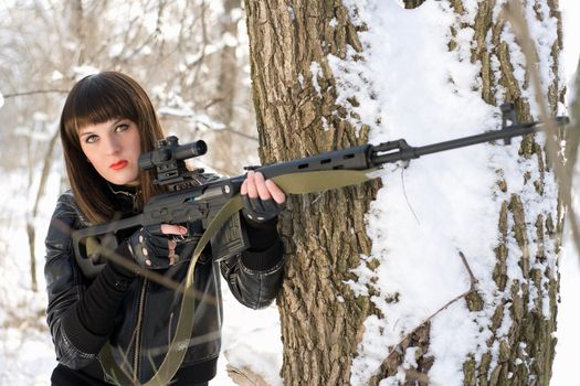 Portrait of young lady with a sniper rifle 