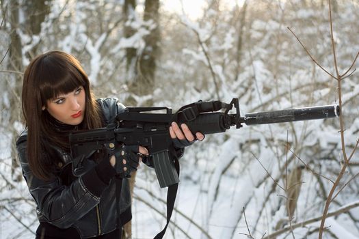 Portrait of attractive young lady with a rifle 