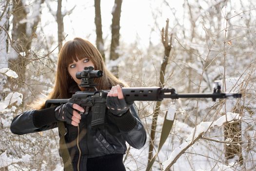 Brunette girl pointing out with a gun