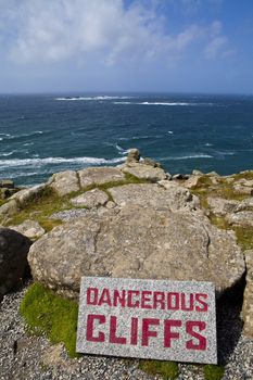 Dangerous Cliffs at Land's End in Cornwall, England.  The Longships Lighthouse can be seen in the distance.