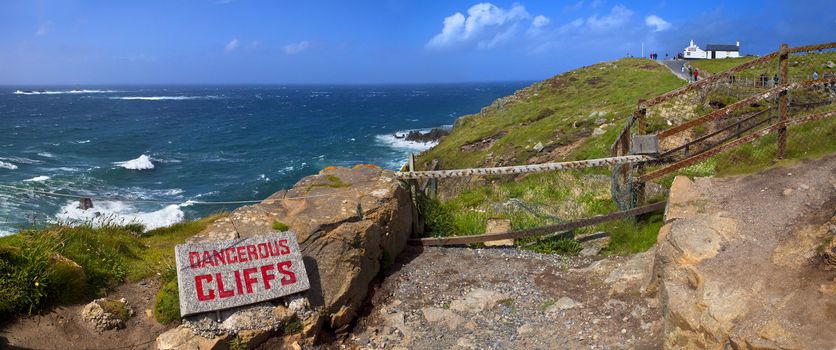 A panorama of Land's End in Cornwall.  The view takes in the sights of Longships Lighthouse on the left and the First and Last refreshments house in England on the right.