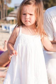 little cute girl smiling playing on beach in summer vacation