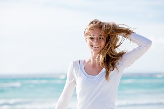 beautiful young woman walking on beach in summer vacation relaxing