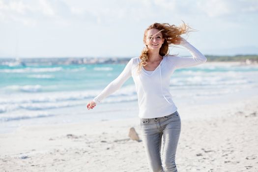 beautiful young woman walking on beach in summer vacation relaxing