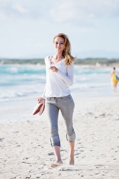 beautiful young woman walking on beach in summer vacation relaxing