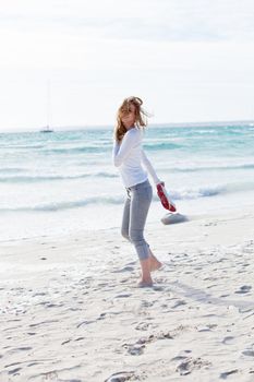 beautiful young woman walking on beach in summer vacation relaxing