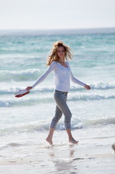 beautiful young woman walking on beach in summer vacation relaxing