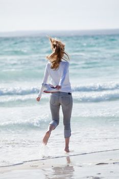 beautiful young woman walking on beach in summer vacation relaxing