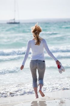 beautiful young woman walking on beach in summer vacation relaxing