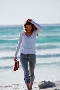 beautiful young woman walking on beach in summer vacation relaxing