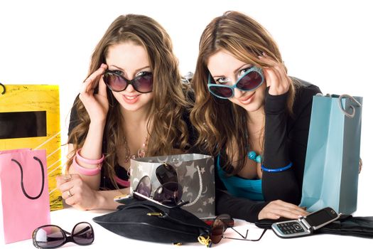 Two smiling beautiful girlfriends in sunglasses after shopping