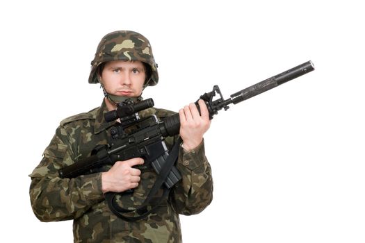 Armed soldier holding m16 in studio. Isolated