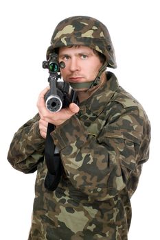 Soldier aiming a rifle in studio. Closeup