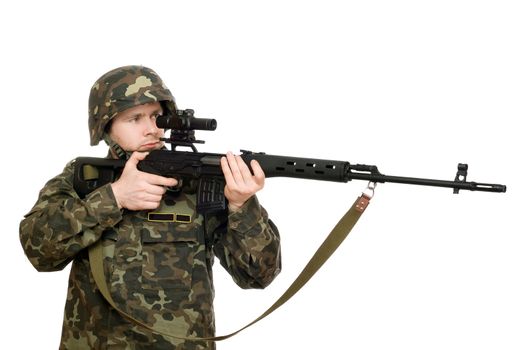 Soldier holding a rifle in studio. Isolated