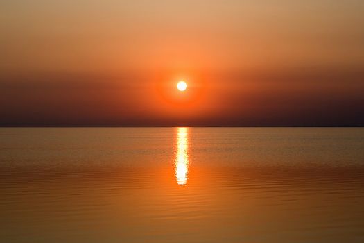 Calm sea bay at the red sunset