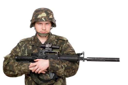 Armed soldier hugging m16 in studio. Isolated