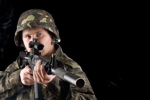 Man keeping a gun in studio. Isolated