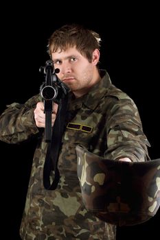 Soldier with m16 begging. Isolated on black
