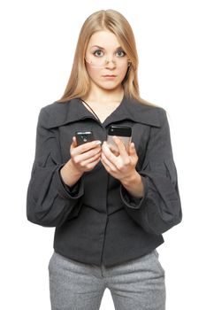 Surprised young blonde in a gray business suit with two phones