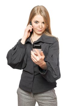 Surprised blonde in a gray business suit with two phones