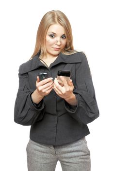 Portrait of surprised young blonde in a gray business suit with two phones