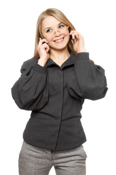 Portrait of smiling young blonde in a gray business suit with two phones