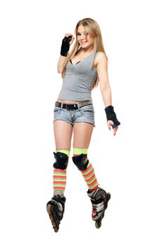 Smiling young woman tries to keep his balance on roller skates