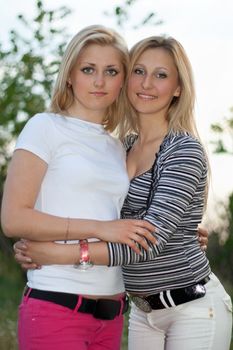 Portrait of two smiling beautiful young women outdoors