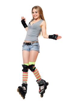 Joyful young woman tries to keep his balance on roller skates