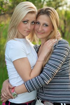Portrait of two beautiful young blonde outdoors