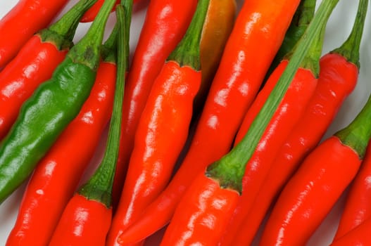 Perfect Red and One Green Chili Peppers Full Frame closeup