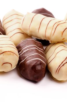 Arrangement of Dark and White Chocolate Glaze Eclairs closeup on white background